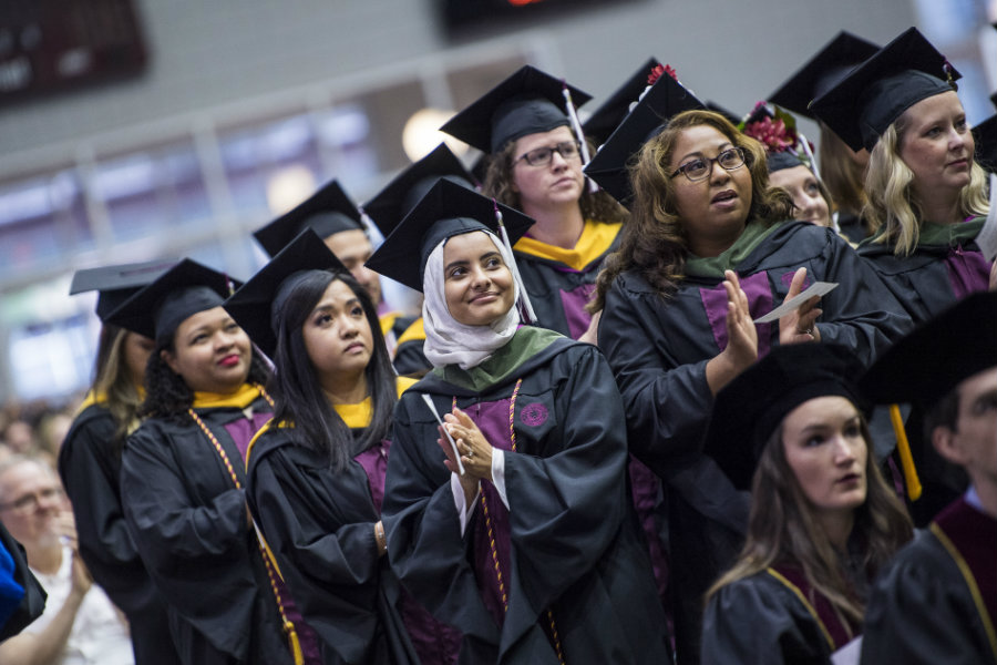 A group of master's graduates at their commencement ceremony.