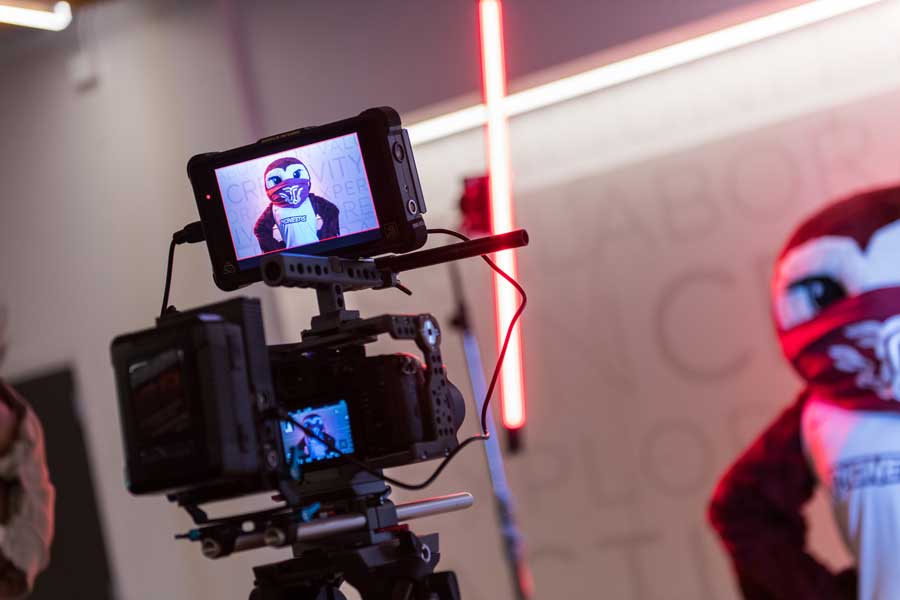 TWU videographer films Oakley in a behind-the-scenes shot of a video shoot.