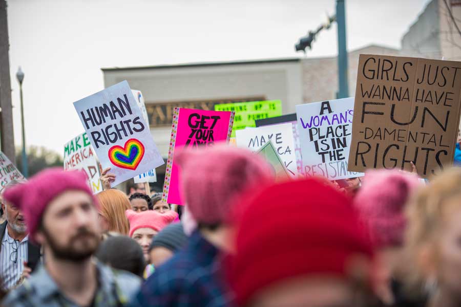Women and men march on the Denton square for human rights.