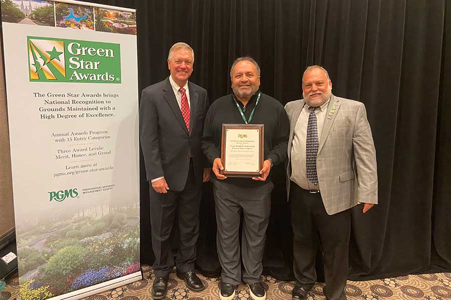 Roberto Trevino, TWU&rsquo;s manager of landscape operations, is flanked by Mark Feist (left), chairman of the Professional Grounds Management Society&rsquo;s Awards Committee and Joe Kovolyan, the organization&rsquo;s president.