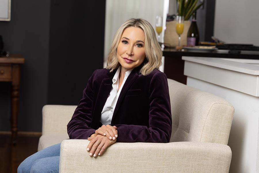 Mindy Patterson sitting on a beige couch