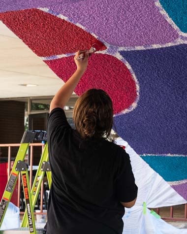 student painting ceiling